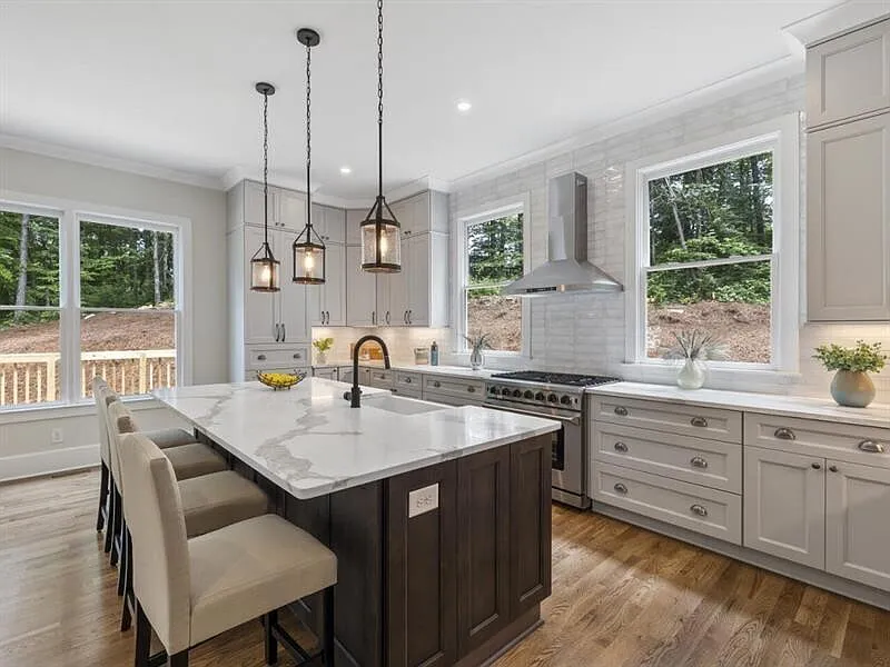 Custom kitchen with long marble island and panoramic natural light